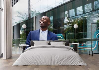 Happy businessman in the city Wall mural