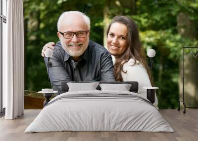 happy mature man smiling with young woman Wall mural