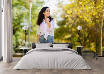 Happy woman admiring view at park Wall mural