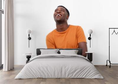 happy young black man laughing and looking up Wall mural