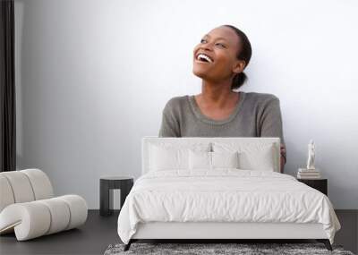 Laughing young african woman against white background Wall mural