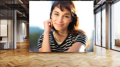 Portrait of attractive young lady sitting outside Wall mural