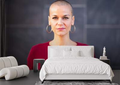 serious woman with shaved head Wall mural