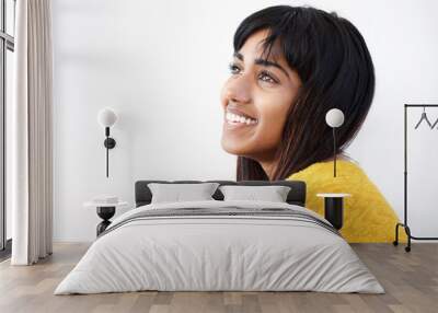 side portrait of cheerful young Indian woman against isolated white background Wall mural