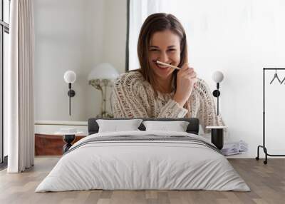 smiling female student working at home Wall mural