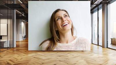 Smiling older woman looking up Wall mural