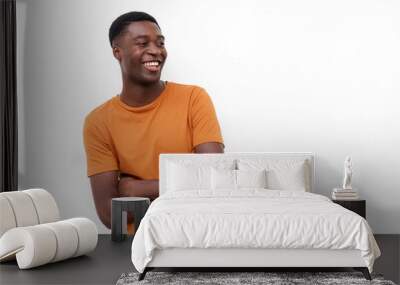 smiling young african american man with arms crossed and t shirt against isolated white background Wall mural