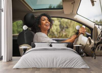 smiling young african american woman driving car Wall mural