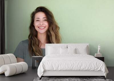 smiling young woman against green background Wall mural