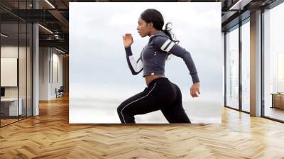 sporty young black woman running Wall mural