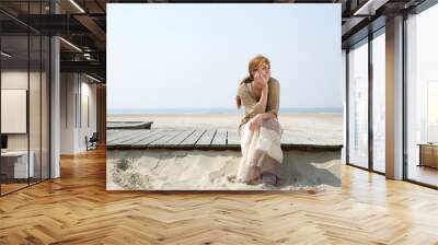 Woman sitting outdoors enjoying summer Wall mural