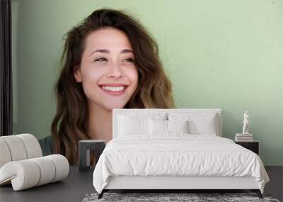 young beautiful woman on green background smiling Wall mural