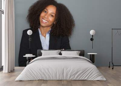 Young business woman smiling with arms crossed Wall mural