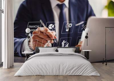 A focused executive engages with a virtual financial planning interface on his laptop, symbolizing sophisticated financial management in a digital era. Wall mural