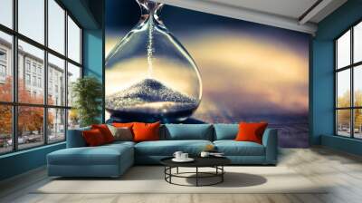 Hourglass as time passing concept for business deadline, urgency and running out of time. Sandglass, egg timer showing the last second or last minute or time out.  With copy space. Wall mural