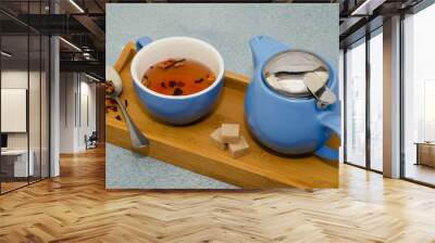 Hibiscus and rose tea in a cup and teapot on a wooden tray Wall mural