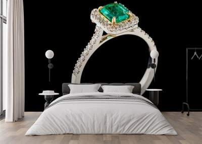 Beautiful white gold ring with diamonds and emerald on a black background Wall mural