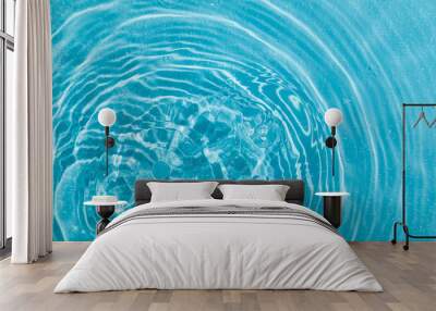 drops on water with circles on a blue background Wall mural