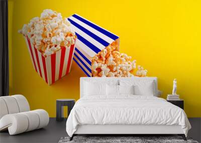 Glass with popcorn on a yellow background Wall mural