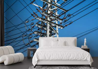 Interlaced poles, blue sky Wall mural