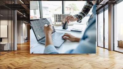 Engineers working together using laptop and blueprint on desk. Wall mural