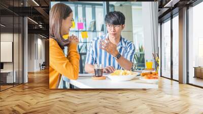 Friends talking and eating pizza in the meeting room. Wall mural