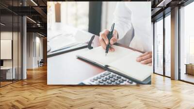 Woman with bills and calculator. Woman using calculator to calculate bills at the table in office. Calculation of costs. Wall mural