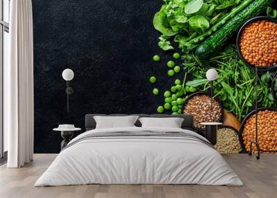 Fresh vegetables and legumes arranged beautifully on a dark surface, perfect for healthy eating and cooking themes. Wall mural