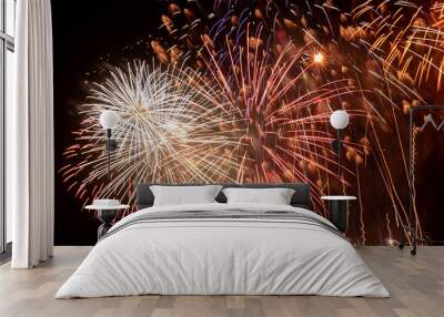 Brightly Colorful Fireworks Light Up the Sky. Beautiful New Year Fireworks. Dark Sky. Explosion. Abstract Colored Firework Background Wall mural