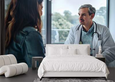 Doctor is explaining something to his patient using his digital tablet during a consultation in his office Wall mural