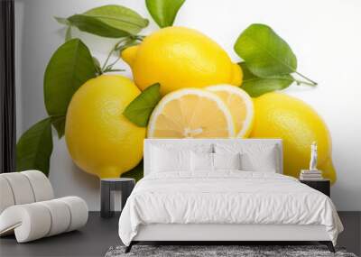 Three whole lemons and two lemon halves with leaves are lying on a white background Wall mural