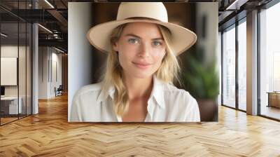 woman wearing panama hat looks at camera. Wall mural