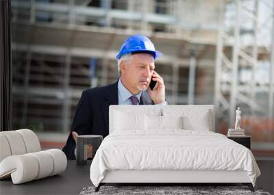 Angry architect talking on the cellphone in front of construction site Wall mural