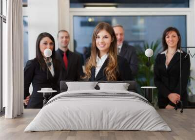 Business woman in front of a group of business people Wall mural