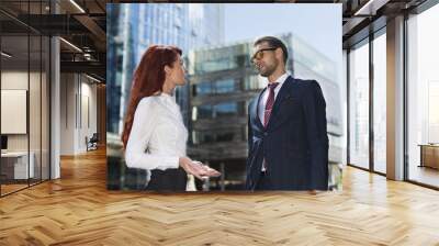 Businessman and businesswoman speaking in a city street Wall mural