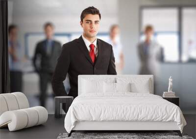 Businessman in front of his team Wall mural