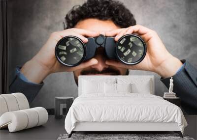 businessman using binoculars, money reflected in the lens Wall mural