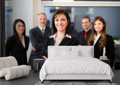 Businesswoman in front of a group of business people Wall mural