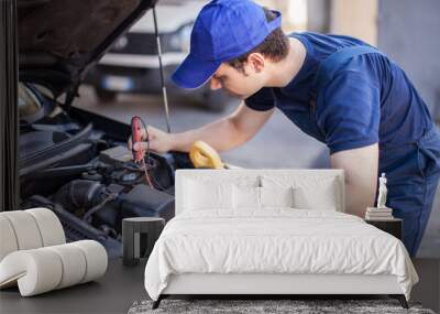 Car electrician troubleshooting a car engine Wall mural