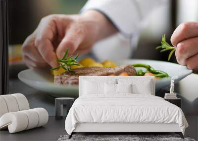 chef hands decorating a dish in restaurant kitchen Wall mural