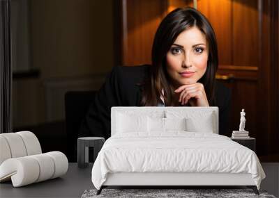 Confident businesswoman sitting at desk in office at night Wall mural