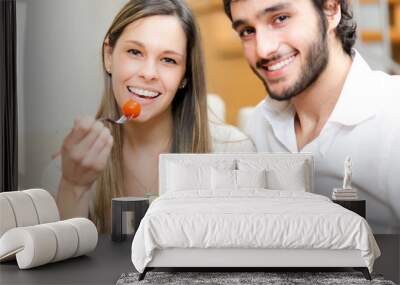 couple eating a salad in the living room Wall mural