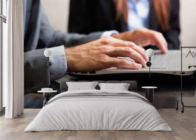 Male hands typing on a laptop keyboard Wall mural