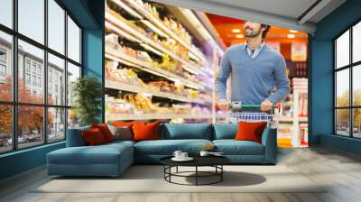 Man shopping in a supermarket Wall mural