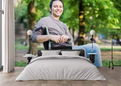 Portrait of a smiling man on a wheelchair Wall mural