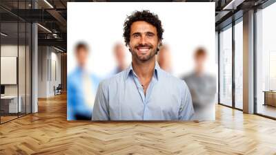 Portrait of a young smiling man in front of a group of people Wall mural