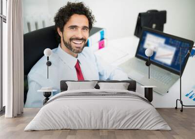 Smiling businessman in his office Wall mural