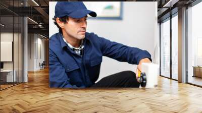 Smiling technician repairing an hot-water heater Wall mural