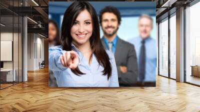 Smiling woman pointing her finger to you Wall mural