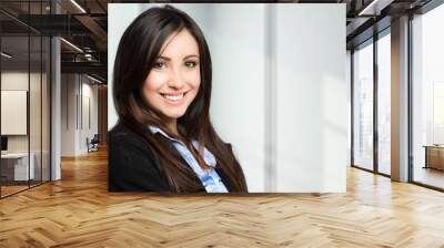 smiling young female manager portrait Wall mural